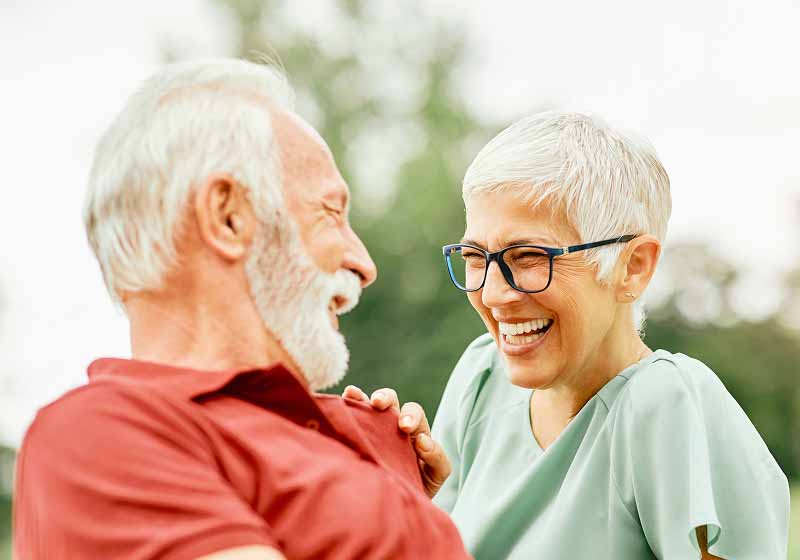 couple with dental implants smiling